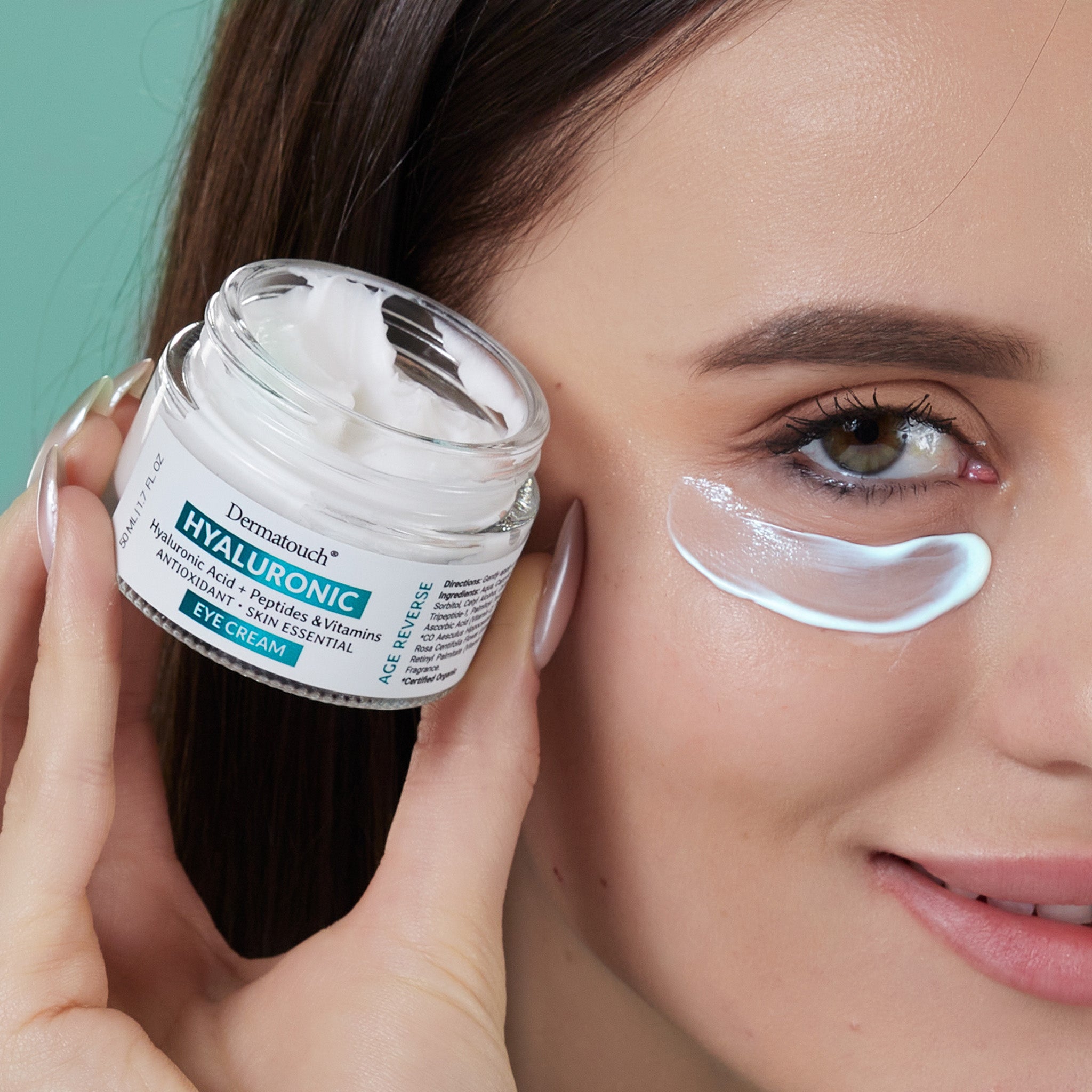 Woman applying eye cream with a jar